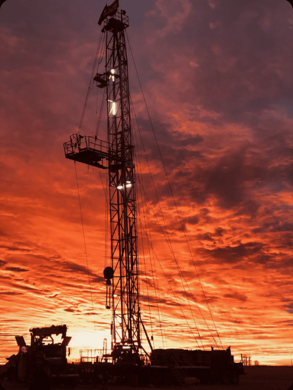 Oil rig working at sunset